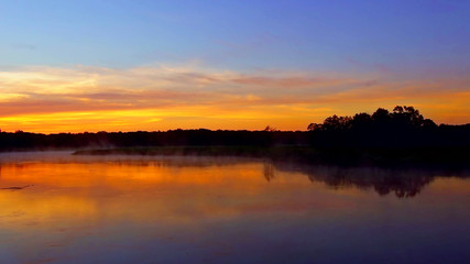 Fototapeta premium tranquil lake sunrise fog morning Landscape tranquil lake sunrise fog