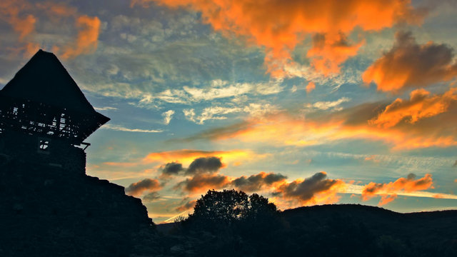 A castle Nevytsky against a pink and mauve sunset sky Ukraine, Zakarpattia Oblast