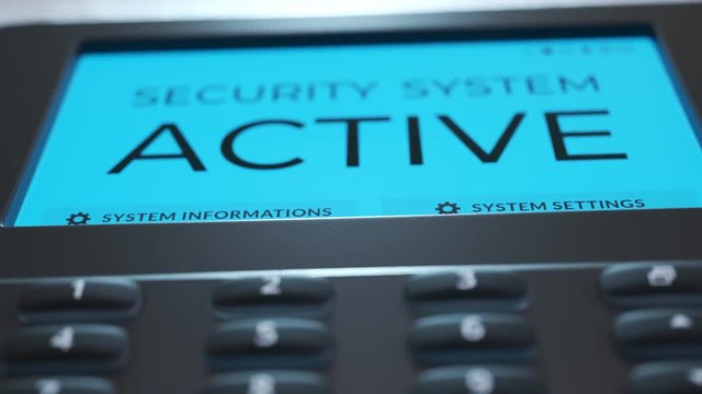Security panel keypad on the wall. Screen showing the alarm being activated.4KHD
