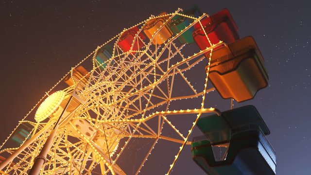 Fun Ferris wheel amusement ride, loopable carousel attraction. Night lights. 4K
