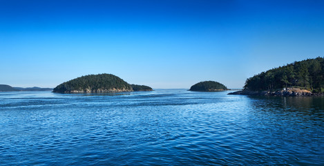 A few of over 100 San Juan Islands on a sunny summer afternoon in Washington