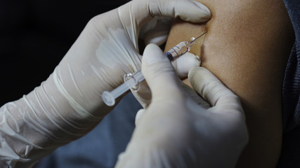 nurse giving a vaccine for a patient