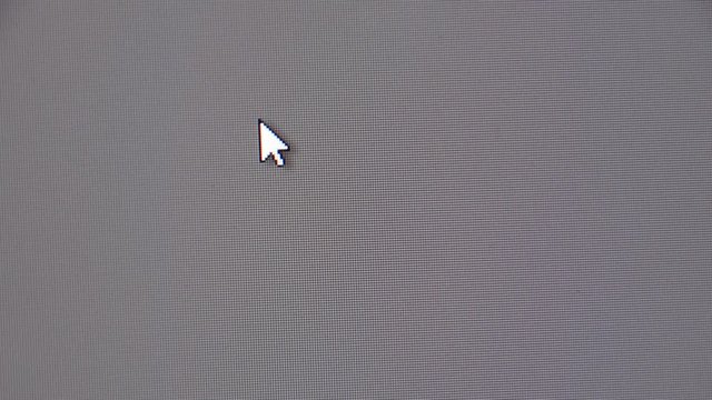 Moving the mouse cursor over the gray screen of the monitor.