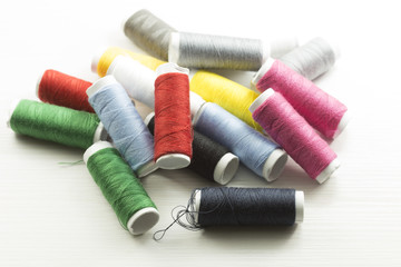 Several bobbins on white