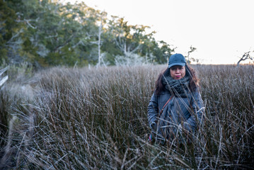 Woman standing in reeds 