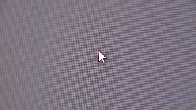 Moving the mouse cursor over the gray screen of the monitor.
