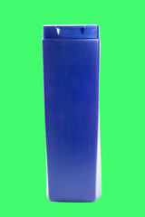 blue bottle of shampoo on a green background