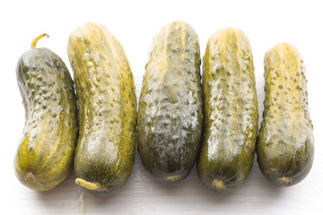salted cucumber on white table