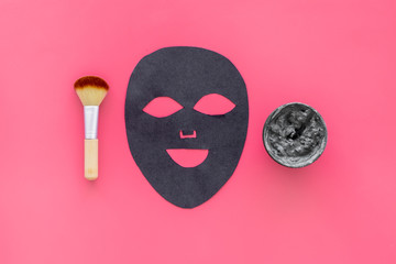 Black facial mask. Black head remover mask. Mask with clay on pink background top view copy space