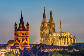 The famous cathedral and Great St. Martin Church in Cologne at dusk