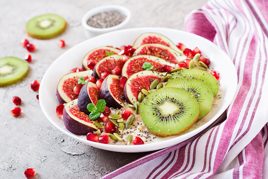 Delicious and healthy oatmeal with figs, kiwi and pomegranate. Healthy breakfast. Fitness food. Proper nutrition.