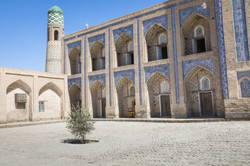 Fototapeta na wymiar Historic buildings at Itchan Kala fortress in the historic center of Khiva. UNESCO world heritage site in Uzbekistan, Central Asia