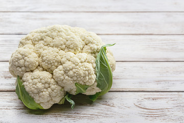 Fresh cauliflower on a white wooden table.