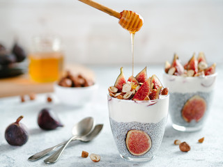 Healthy chia pudding with yogurt, figs and nuts in glass. Ideas and recipes for healthy breakfast,...