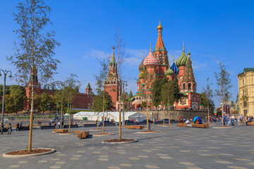 Green trees and grass on the background of the Moscow Kremlin and the red square in the park Zaryadye