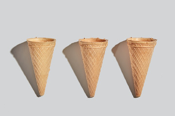 Wafer sweet cones pattern on a white background with ahadows. Flat lay.