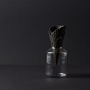 Glass Jar With Wafer Cone For Ice Cream On A Black Background.