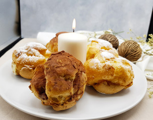 Chocolate and vanilla choux cream puff with candle