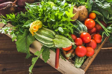 Gordijnen Healthy organic food. Garden produce and harvested vegetable. Fresh farm vegetables in wooden box. Autumn harvest. © alicja neumiler