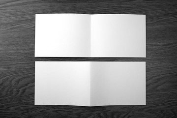 Mockup of white booklet on wooden background.