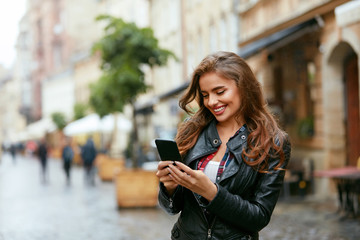 Woman Using Phone On Street 