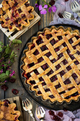 Traditional American cherry pie on a dark wooden background
