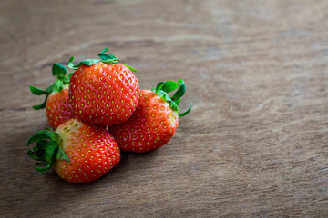 Red strawberry on wooden floor