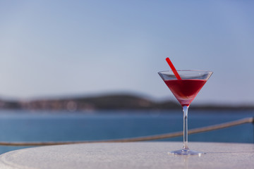 Cold glass of aperol spritz appetizer stand on table near the river
