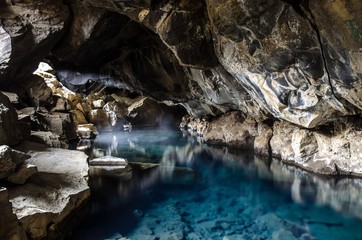  Lava Cave Grjotagja with crystal blue thermal Water near Myvatn Iceland