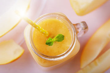 Smoothies in a glass jar, made from pieces of melon, top view