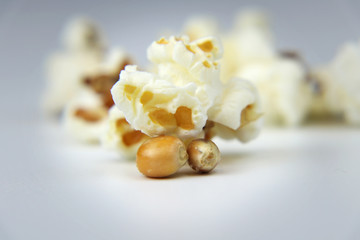 A one delicious piece of popcorn and in the background there are rest of groups