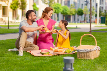 Delicious food. Nice happy father and daughter smiling while taking hamburgers from the plate