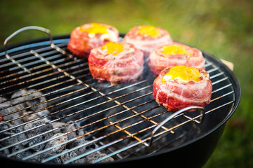 Making home made Beer Can Bacon Burgers on barbecue grill.