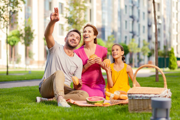 In that direction. Joyful positive man pointing with his hand while showing something interesting...
