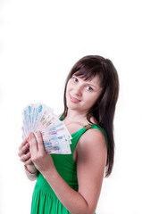 Happy brunette girl in green dress holding money