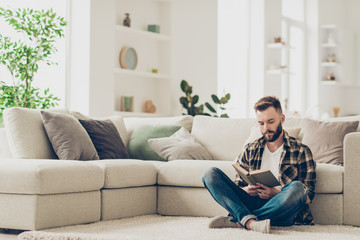 Attentiveand thoughtful man in checkered brown shirt sit on the 