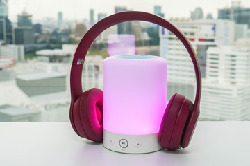 pink cute wireless headphone on bluetooth portable speaker with lighting option for music connection