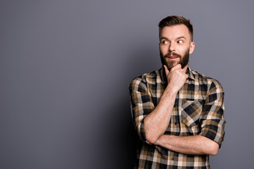 Young emotional careless man isolated on gray background with co
