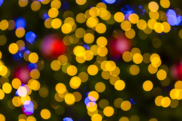 Golden Bokeh of Christmas balls and Christmas tree with light
