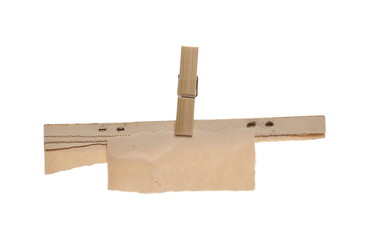 Crumpled cardboard paper with clothes pin isolated on white background, clipping path