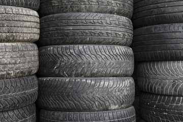 Obraz premium Pile of old used rubber tyres
