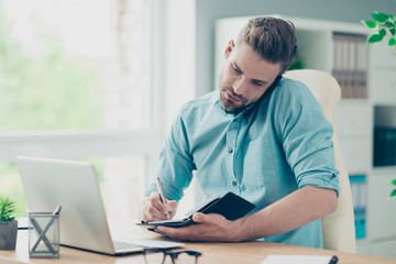 Handsome, attractive, bearded man sits in a trendy casual stylis