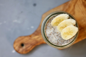 chia pudding with banana on wooden deck