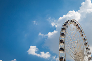 White big Ferris wheel  with blue sky sharp clouds