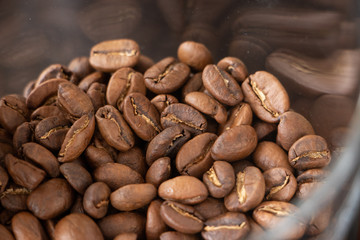 Roasted coffee beans background. Espresso dark, aroma coffee beans in glasses jar.