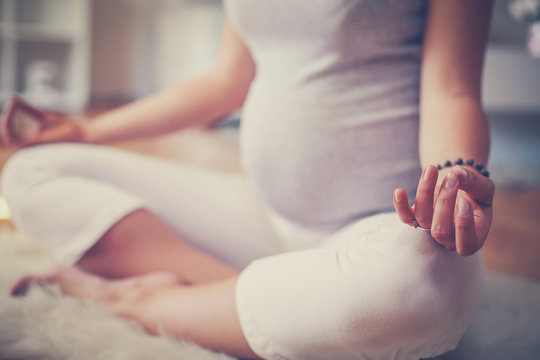 Close up of pregnant woman. Woman doing  meditation.