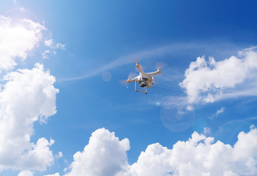 Flight drone, quadcopter on a blue sky background.