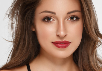 Fototapeta premium Beautiful woman brunette with tanned skin and red lips beauty 