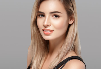 Fototapeta premium Beautiful blonde woman with curly blonde hair isolated on white with healthy skin and hairstyle female portrait natural makeup