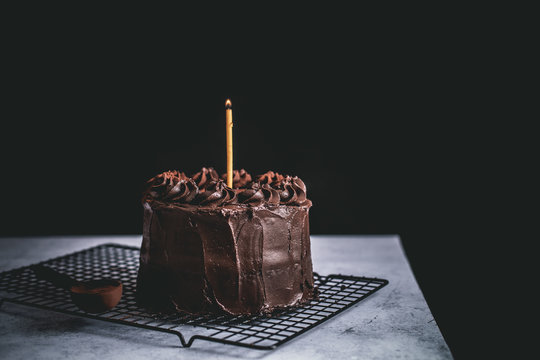 Chocolate Birthday Blackout Cake With A Burning Candle